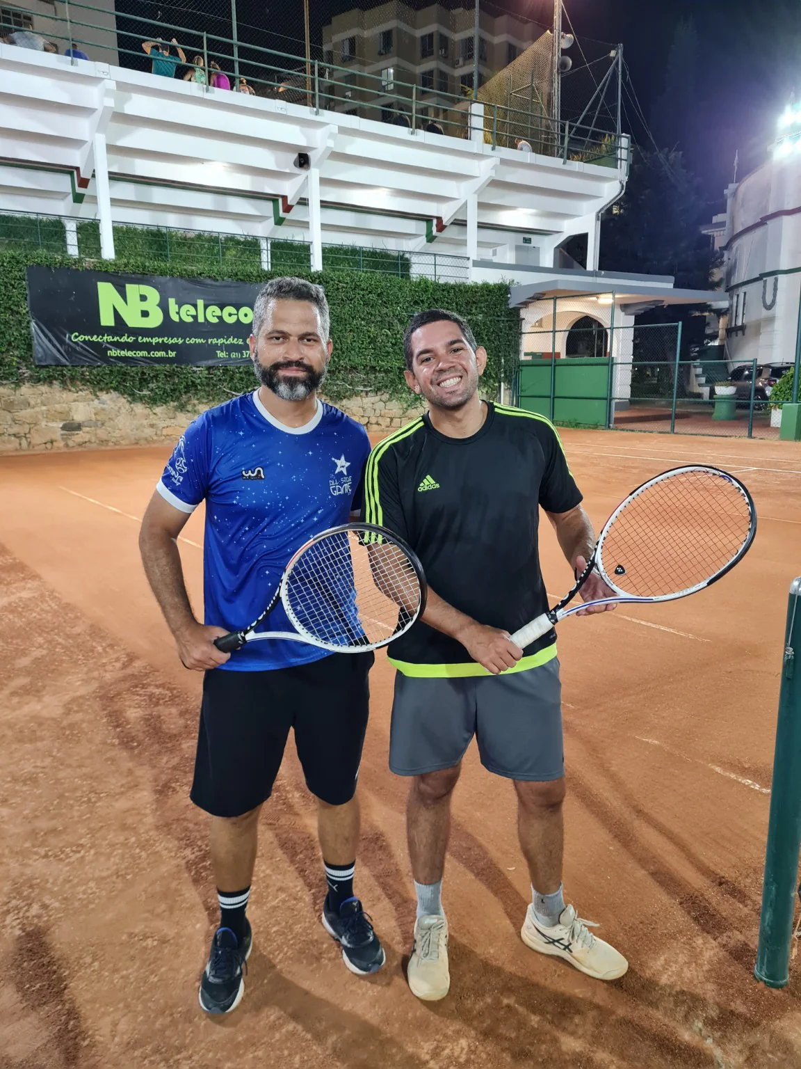Dr. Juan Aquino com seu primo, segurando raquetes de tênis na quadra do Fluminense, em Laranjeiras.